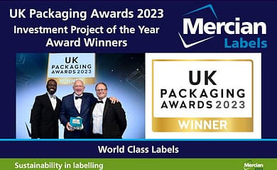 Picture of 3 men on stage in dinner jackets and bow ties, with Jean-Michel Sintome, Operations Director from Mercian Labels, receiving the UK Packaging Awards 2023 trophy from Ortis Deley